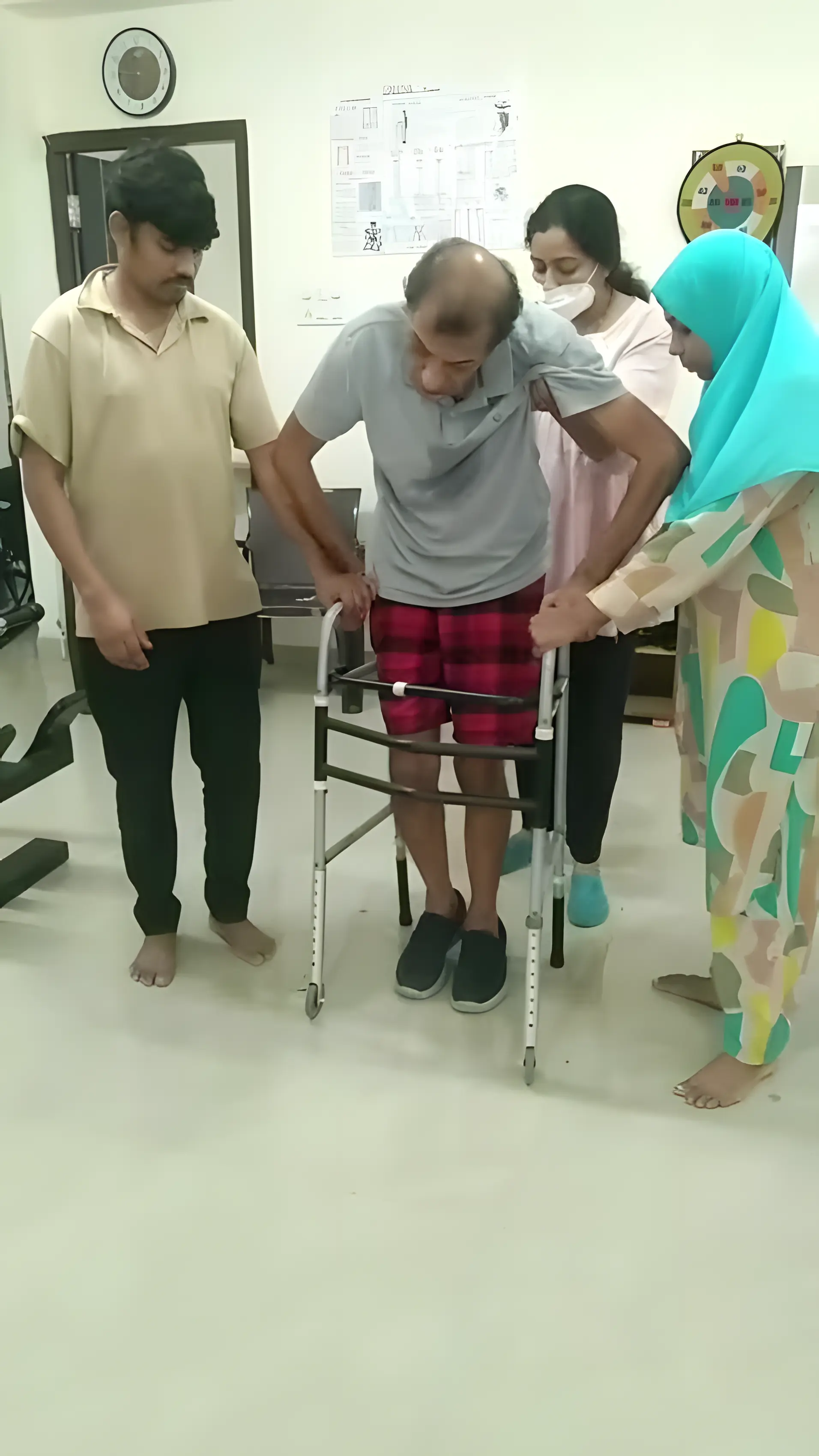 Physiotherapist assisting a patient with active assisted abdominal strengthening using a spring at Regen Neuro Rehabilitation Physiotherapy Centre