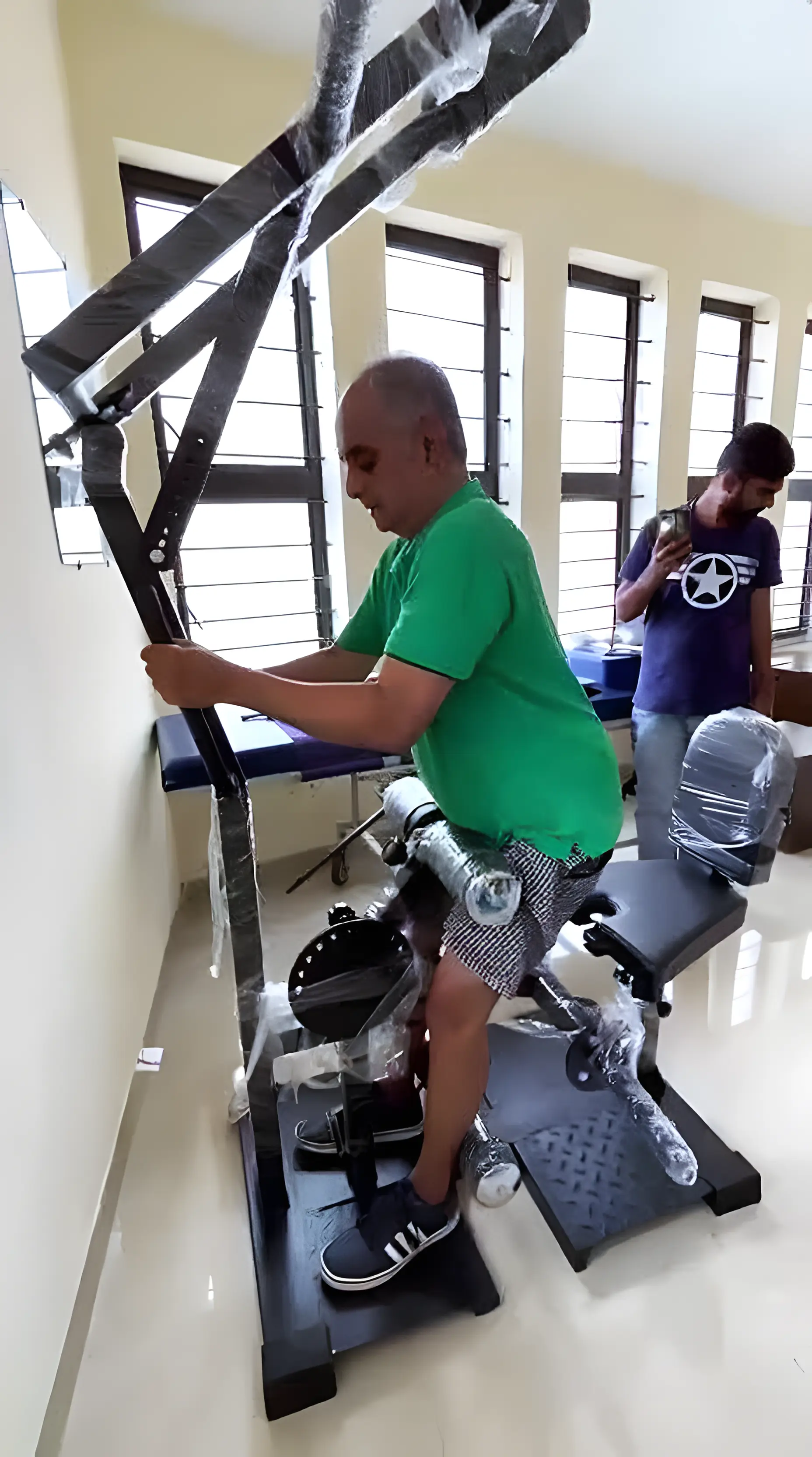 Physiotherapist assisting a Stroke patient with resisted sit-to-stand exercise at Regen Neuro Rehabilitation Physiotherapy Centre