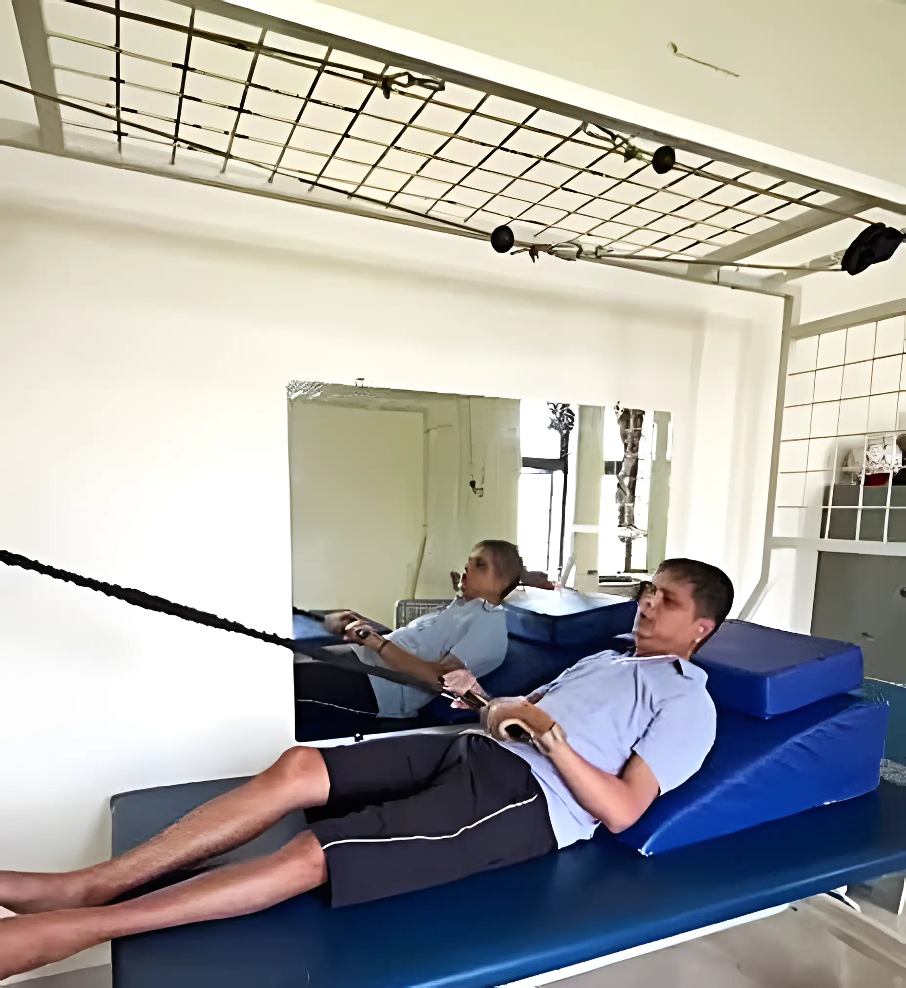 Physiotherapist assisting a patient graduating from higher support to lower support using orthotic and manual support at Regen Neuro Rehabilitation Physiotherapy Centre
