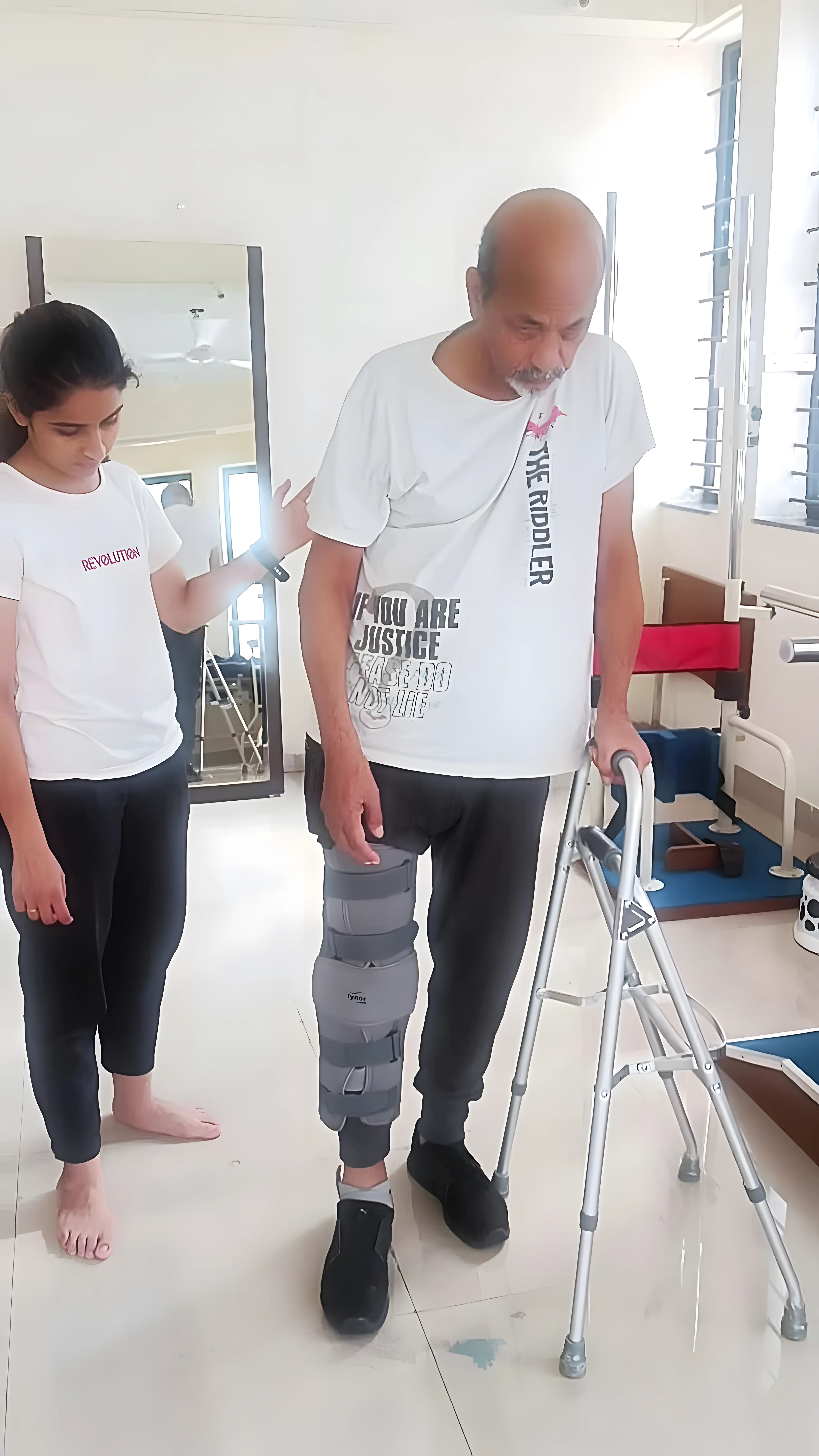 Physiotherapist assisting a Hemiplegic patient with gait training using a Hemi walker and long knee brace at Regen Neuro Rehabilitation Physiotherapy Centre