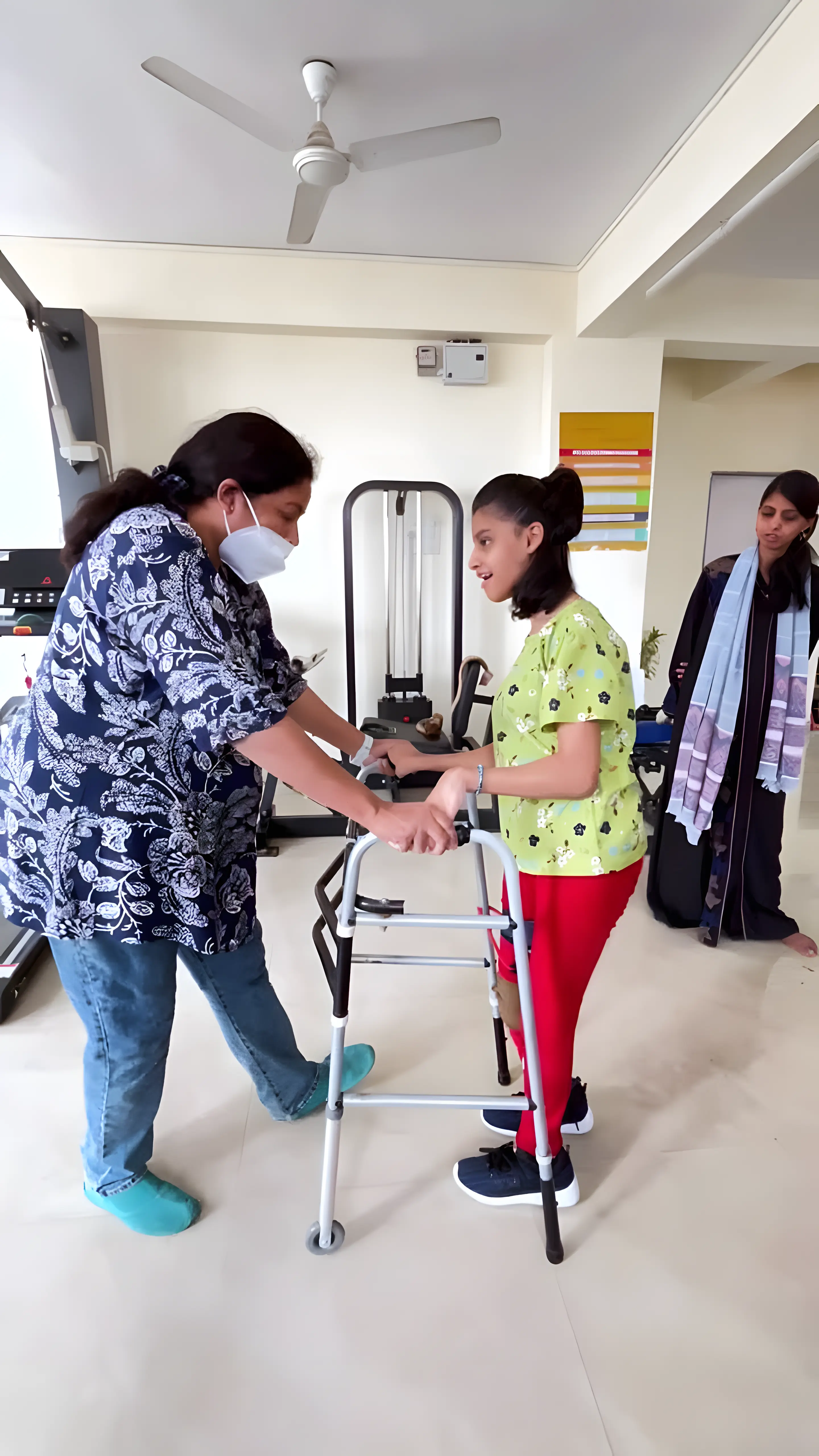 Physiotherapist assisting a Cerebral Palsy patient with gait training using Knee-Ankle-Foot Orthosis (KAFO) at Regen Neuro Rehabilitation Physiotherapy Centre